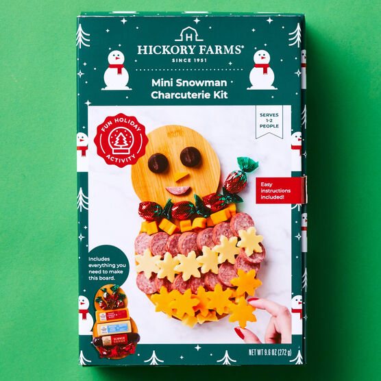 Hickory Farms Mini Snowman Charcuterie Board Kit box on a green background