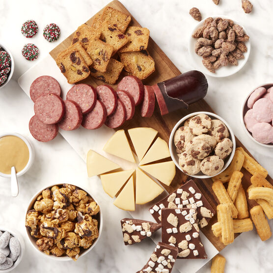 Holiday Cheer Gourmet Gift Basket meat and cheeses slices and arranged on board with snacks
