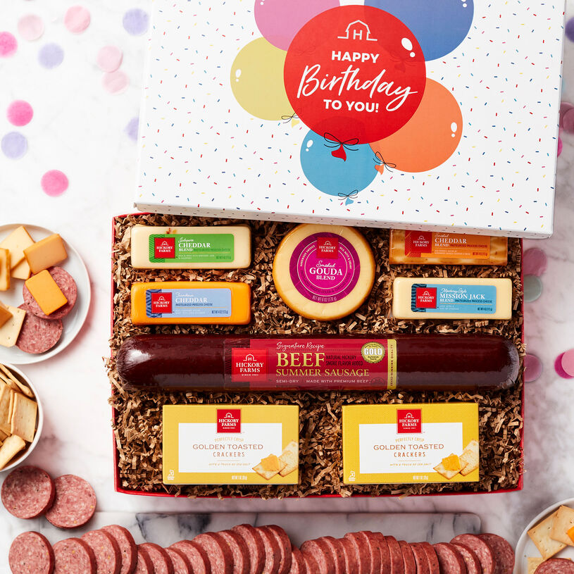 This birthday confetti gift box is filled with our party-size Signature Beef Summer Sausage, Smoked Gouda, Smoked Cheddar, Jalapeño Cheddar Blend, Farmhouse Cheddar, Mission Jack Blend, and Golden Toasted Crackers. 