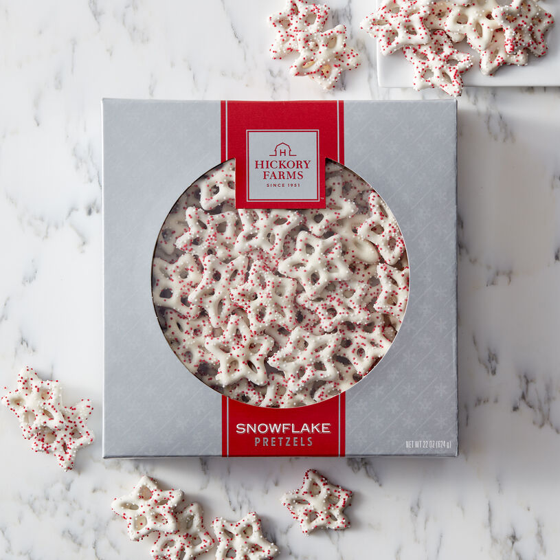 Delicate snowflake-shaped pretzels drenched with creamy white confection and sprinkled with miniature nonpareils.