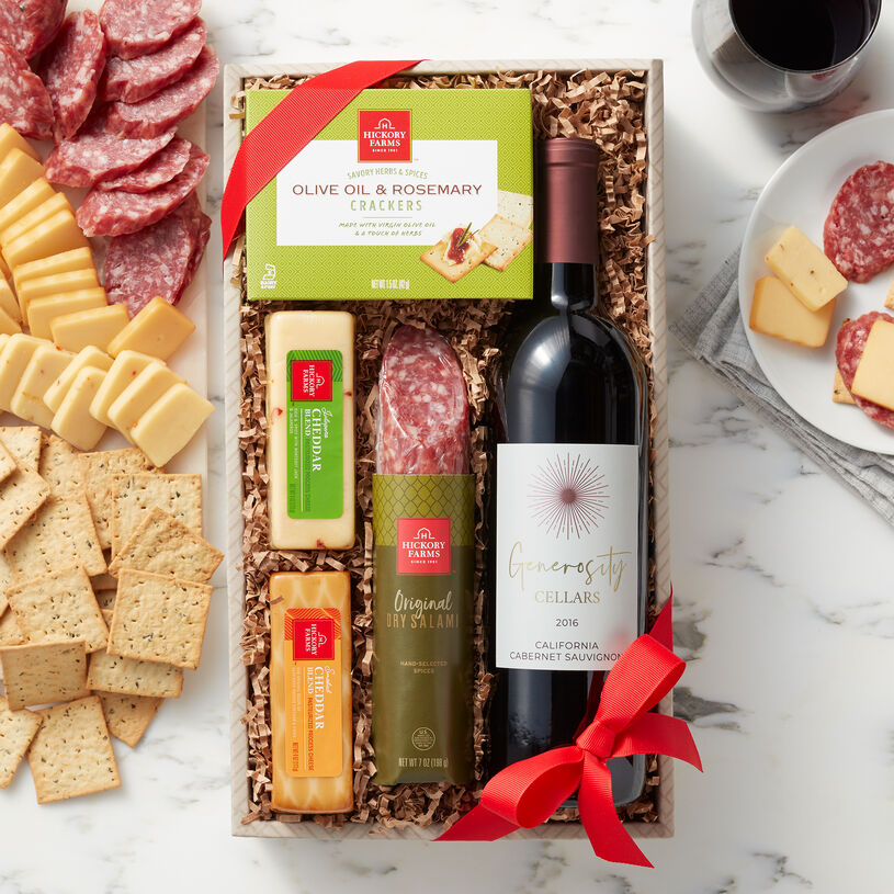 The Hickory Farms Wine & Savory Snack Collection includes a bottle of wine, salami, cheese, and crackers.