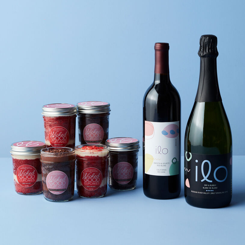 This gift includes three Wicked Good Cupcakes Chocolate Ganache and three Red Velvet Cupcake Jars paired with Ilo California Brut Blanc de Blanc and Red Blend wines.