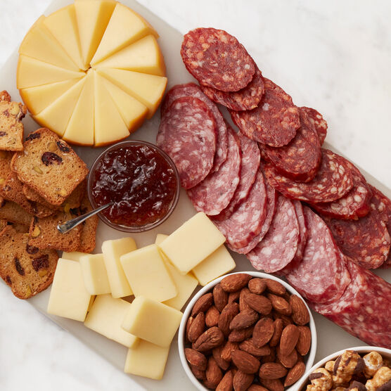 Alternate view of Hickory Farms dry salami on a charcuterie board with spicy salami, smoked gouda cheese, and hot pepper bacon jam