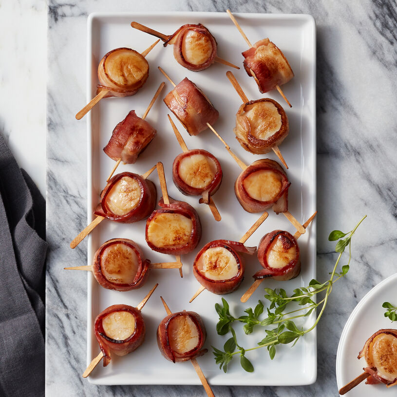 These bacon wrapped scallops are hand-made using premium seafood along with Nueske’s Applewood Smoked Bacon. 