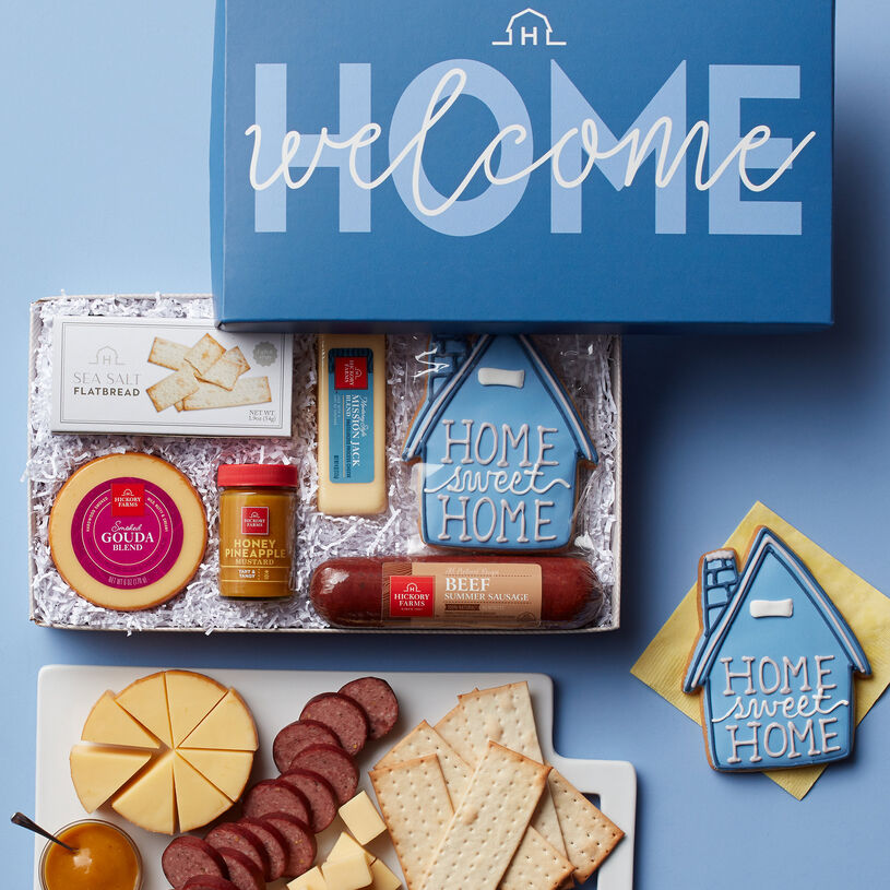 This housewarming gift box features All-Natural Beef Summer Sausage, Smoked Gouda Blend, Mission Jack Blend, Honey Pineapple Mustard, and Sea Salt Flatbread, and a Home Sweet Home Sugar Cookie.