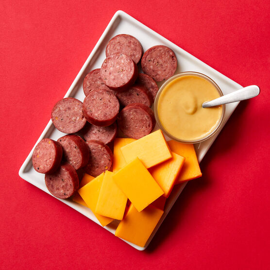 Classic Meat and Cheese Stocking Stuffer components sliced and arranged on a white plate