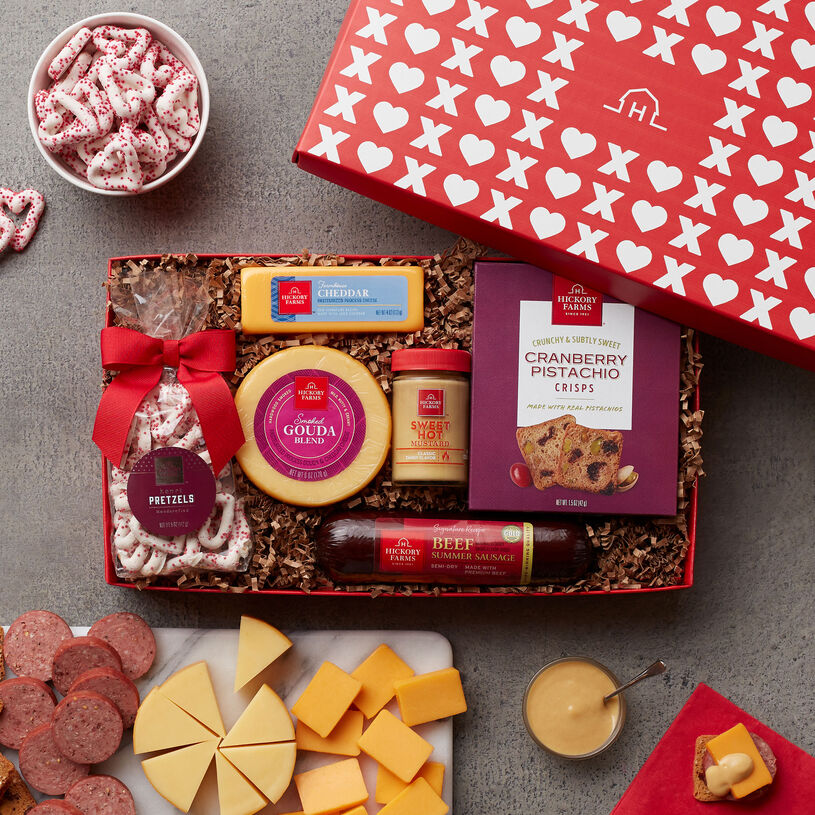 Valentine's Day Gift box includes summer sausage, cheese, mustard, nuts, and valentine's day pretzels.