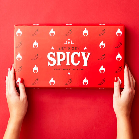 Red lid that says Let's Get Spicy on red background