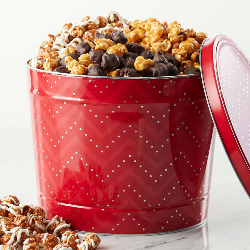 Premium Caramel Corn with Nuts, White Chocolate Snickerdoodle, and Dark Chocolate Sea Salt Caramel are beautifully packed in a festive red tin.