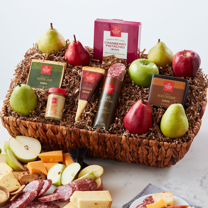 The Gourmet Entertainment Gift Basket includes pears, apples, salami, cheese, and crisps.