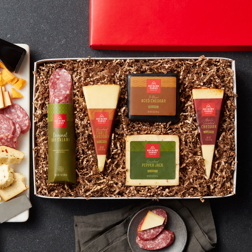 The Gourmet Cheese & Salami Gift Box includes dry salami, smoked garlic cheddar, 3 year aged cheddar, smoked pepper jack, and apple smoked cheddar with paprika