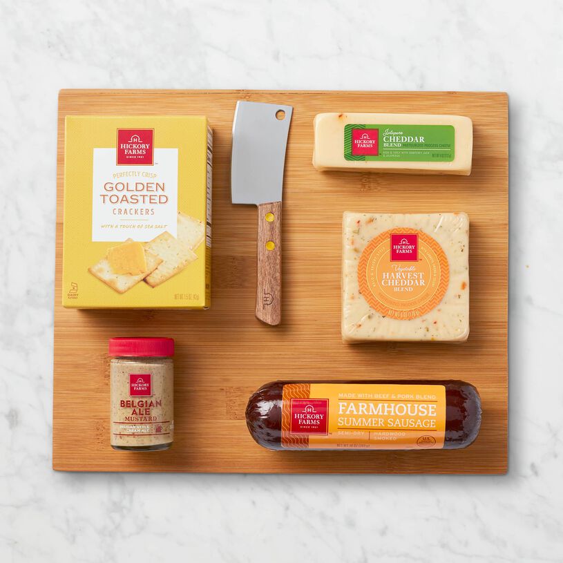 This gift includes Farmhouse Summer Sausage, Jalapeño Cheddar Blend, Harvest Cheddar Blend, Belgian Ale Mustard, Golden Toasted Cracker, a Bamboo Cheese Board and Cheese Cleaver. 
