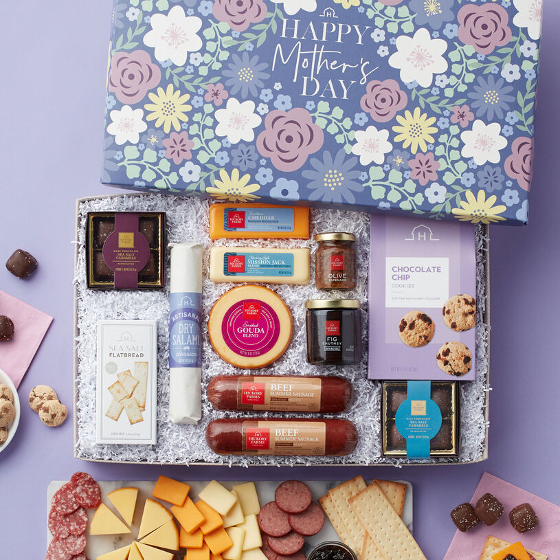 Mother's Day Charcuterie gift filled with  All-Natural Beef Summer Sausage, Dry Salami, Gouda, Mission Jack, Cheddar, Olive Tapenade, Fig Chutney, Sea Salt Flatbread, chocolates, and cookies.