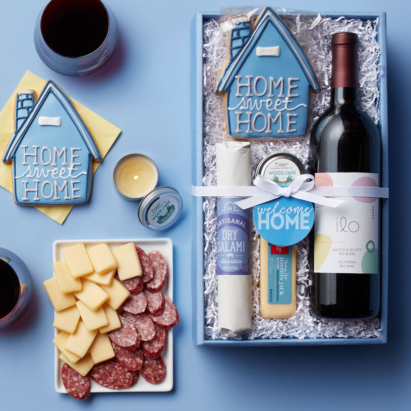 This housewarming gift features Classico Dry Salami, Mission Jack, a Home Sweet Home Sugar Cookie, Wood Sage Sea Salt Travel Candle, and Ilo California Red Blend Wine.