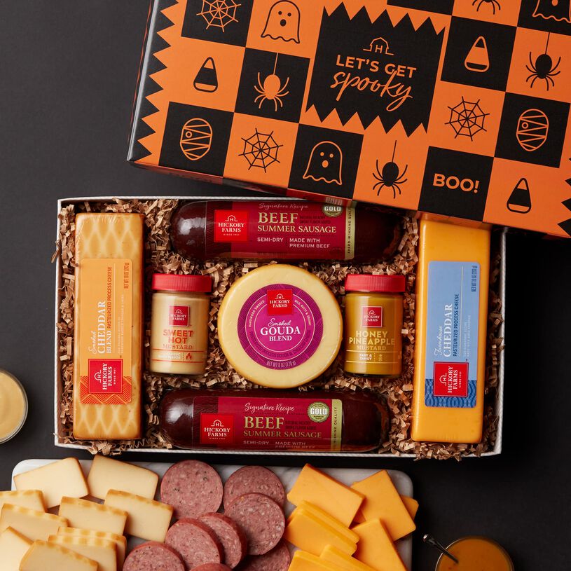 This Halloween gift box includes Signature Beef Summer Sausage, Smoked and Farmhouse Cheddar, Smoked Gouda Blend, and Sweet Hot and Honey Pineapple Mustards.