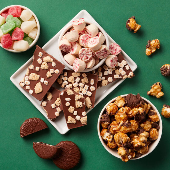 Holiday Sweets Gift Tower components arranged on a plate on a green background