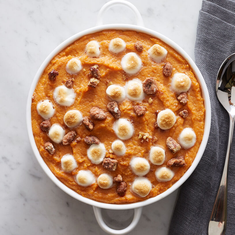Cooked sweet potatoes are seasoned with brown sugar and cinnamon, then topped with praline pecans and marshmallows for a pretty (and delicious!) presentation.