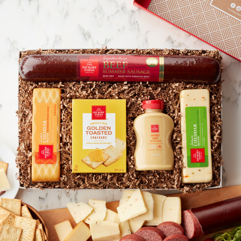 This gift is packed with Hickory Farms favorites: Signature Beef Summer Sausage, Smoked Cheddar and Jalapeño Cheddar Blend cheeses, Sweet Hot Mustard, and Golden Toasted Crackers to stack up a timeless snack.