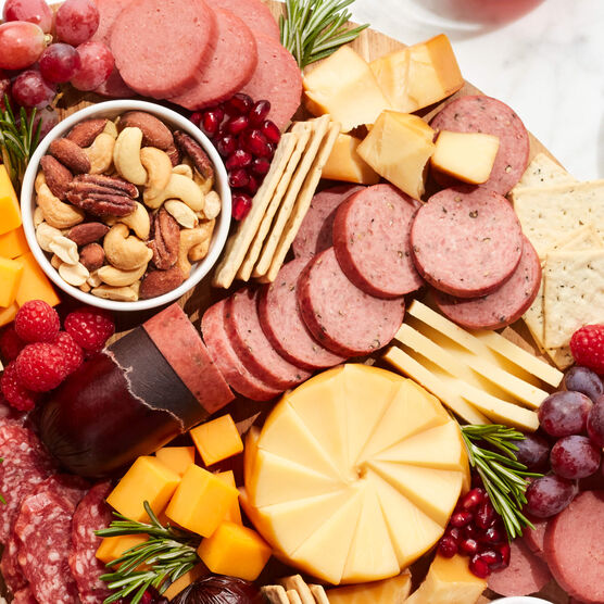 Cracked Pepper Summer Sausage and other snacks on a charcuterie board