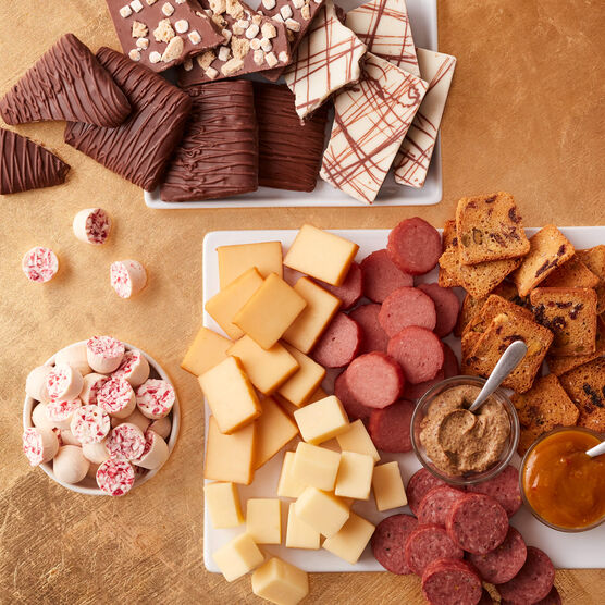 Solid Gold Gift Tower meats, cheeses, and snacks arranged on a gold background