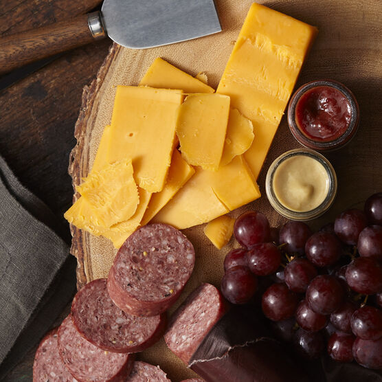 Assortment includes beef summer sausage, farmhouse cheddar cheese, sweet hot mustard, and cranberry mustard