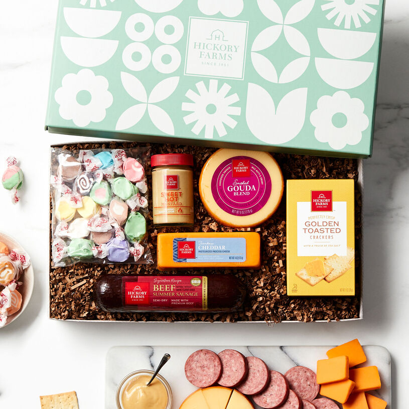 This spring gift is filled with Beef Summer Sausage, Farmhouse Cheddar, Smoked Gouda Blend, Sweet Hot Mustard, Golden Toasted Crackers, and taffy.
