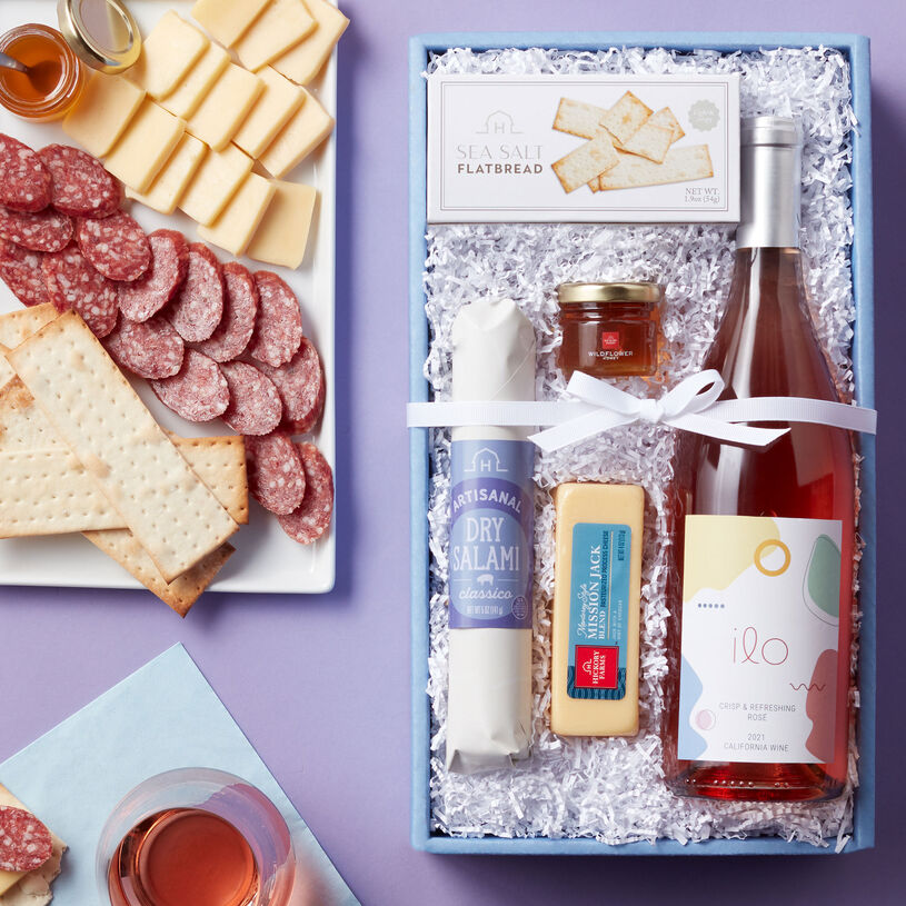 Wine gift set features Classico Dry Salami, Wildflower Honey, Sea Salt Flatbread, and Ilo California Rosé wine.