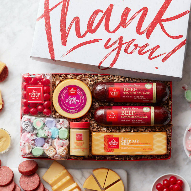 A photo of an opened thank you gift for healthcare workers, featuring a motivational tumbler, tea, coffee, and sweets.