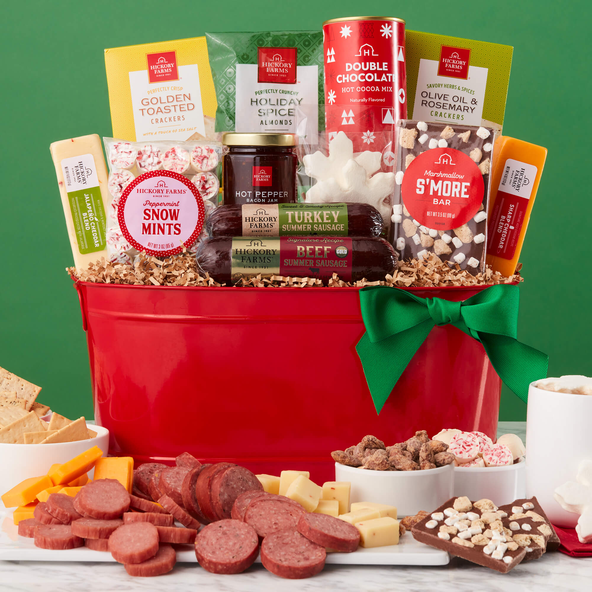 Happy Holidays Gift Basket includes beef sausage, turkey sausage, various cheeses, crackers, jam, almonds, and mints