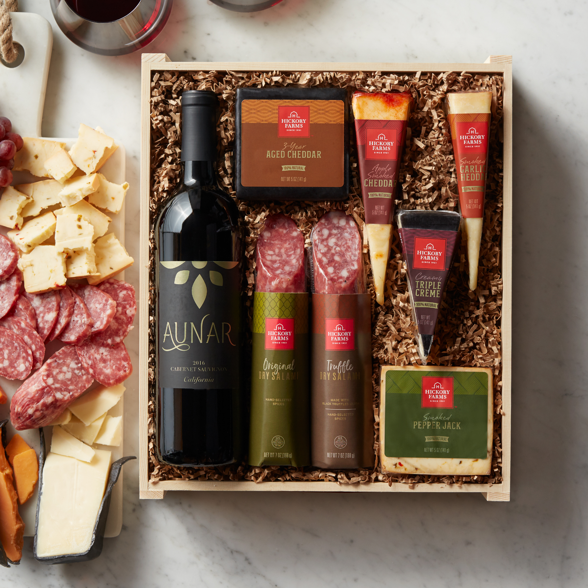 Our Dry Salami and Three Pepper Salami are paired with five different artisan cheeses and hand-packed with a bottle of Aunar California Cabernet Sauvignon