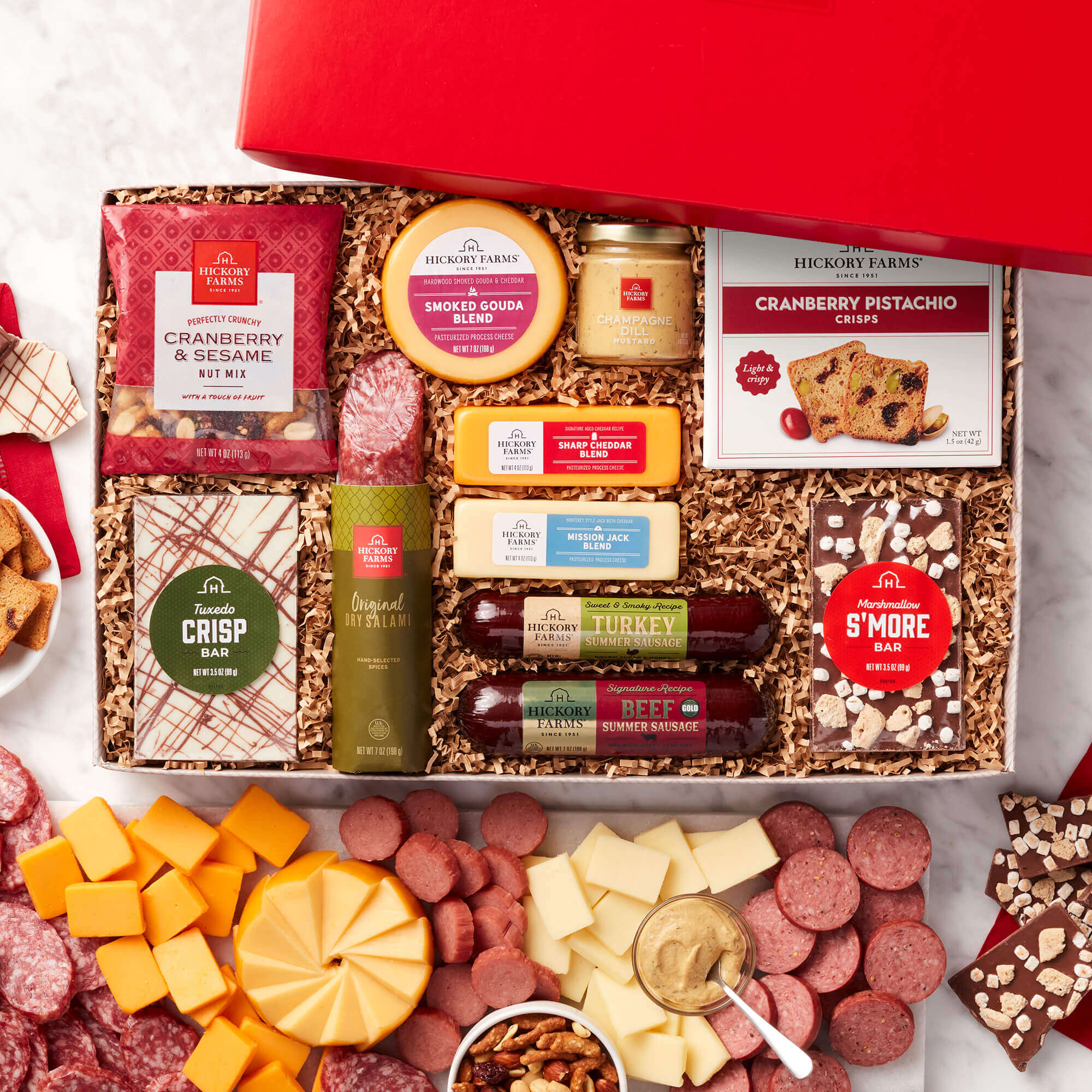 Premium Charcuterie & Chocolate Gift Box includes beef and turkey sausages, salami, mustard, various cheeses, and chocolates