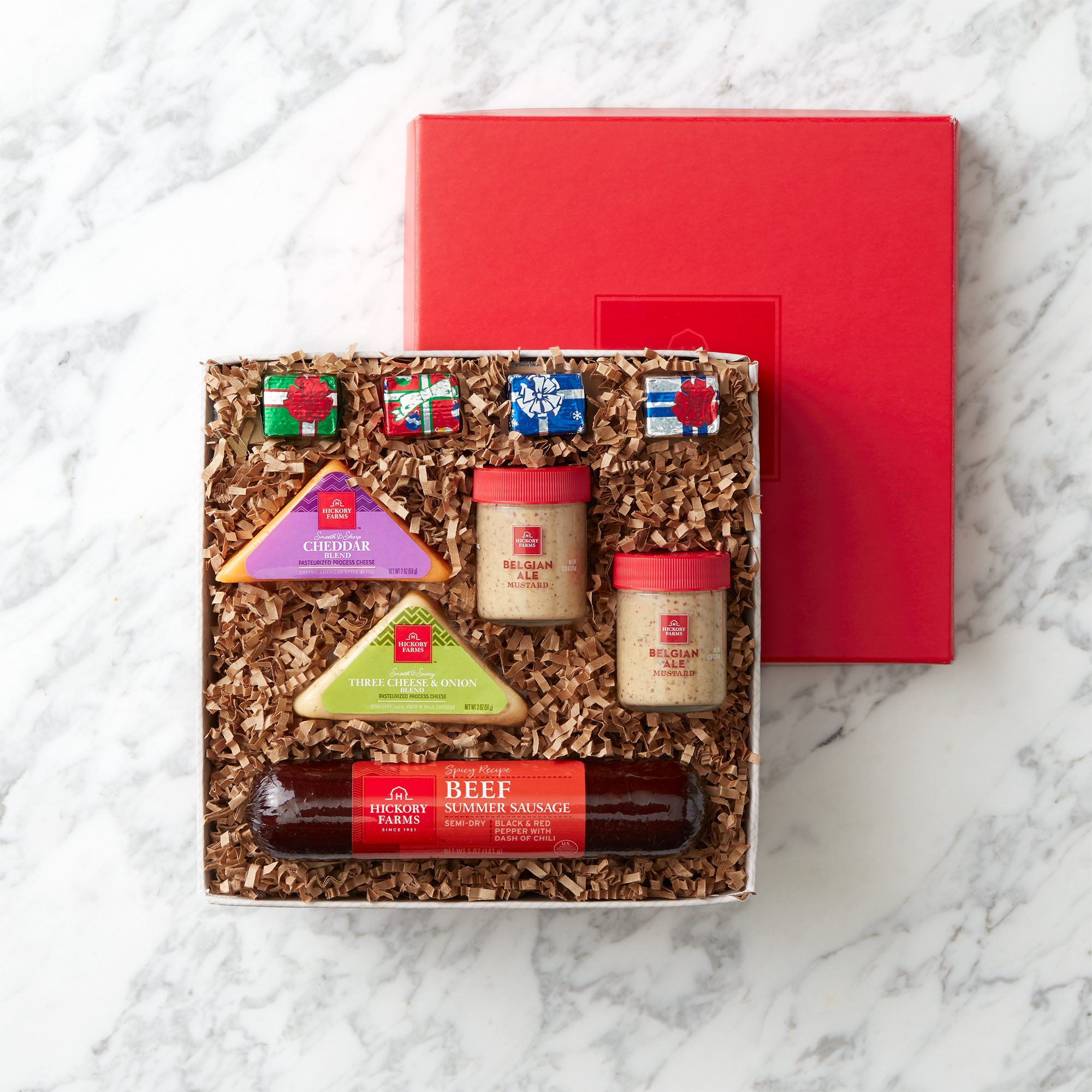 Spicy Beef Summer Sausage, Smooth & Sharp Cheddar Blend, Three Cheese & Onion Blend cheeses, Belgian Ale Mustard, and Chocolate Wrapped Presents.