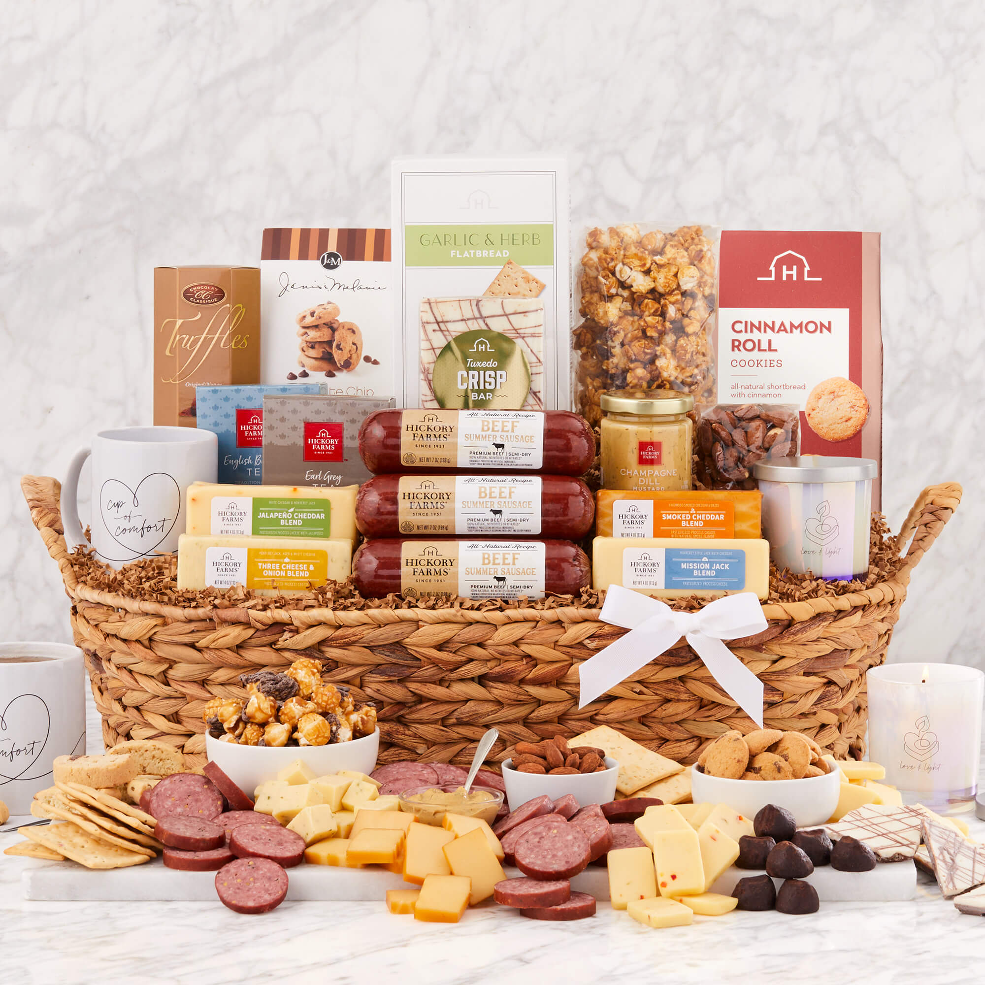 Sending Comfort Gift Basket includes three sausages, various cheeses, crackers, popcorn, cookies, chocolate, and nuts