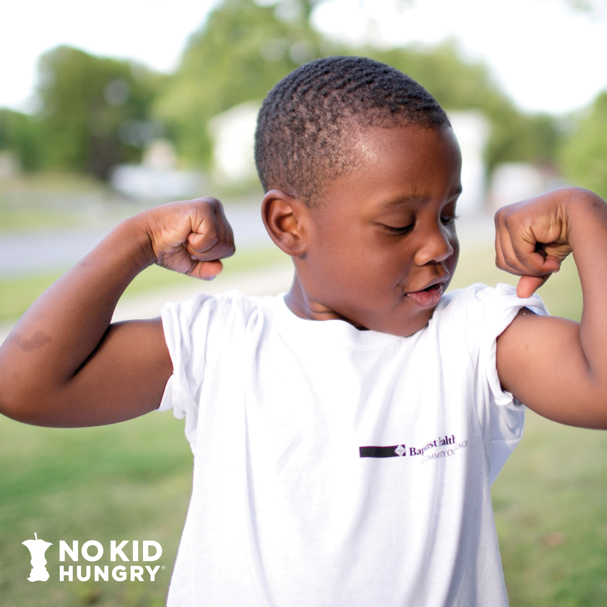 No Kid Hungry Boy flexing muscles smiling