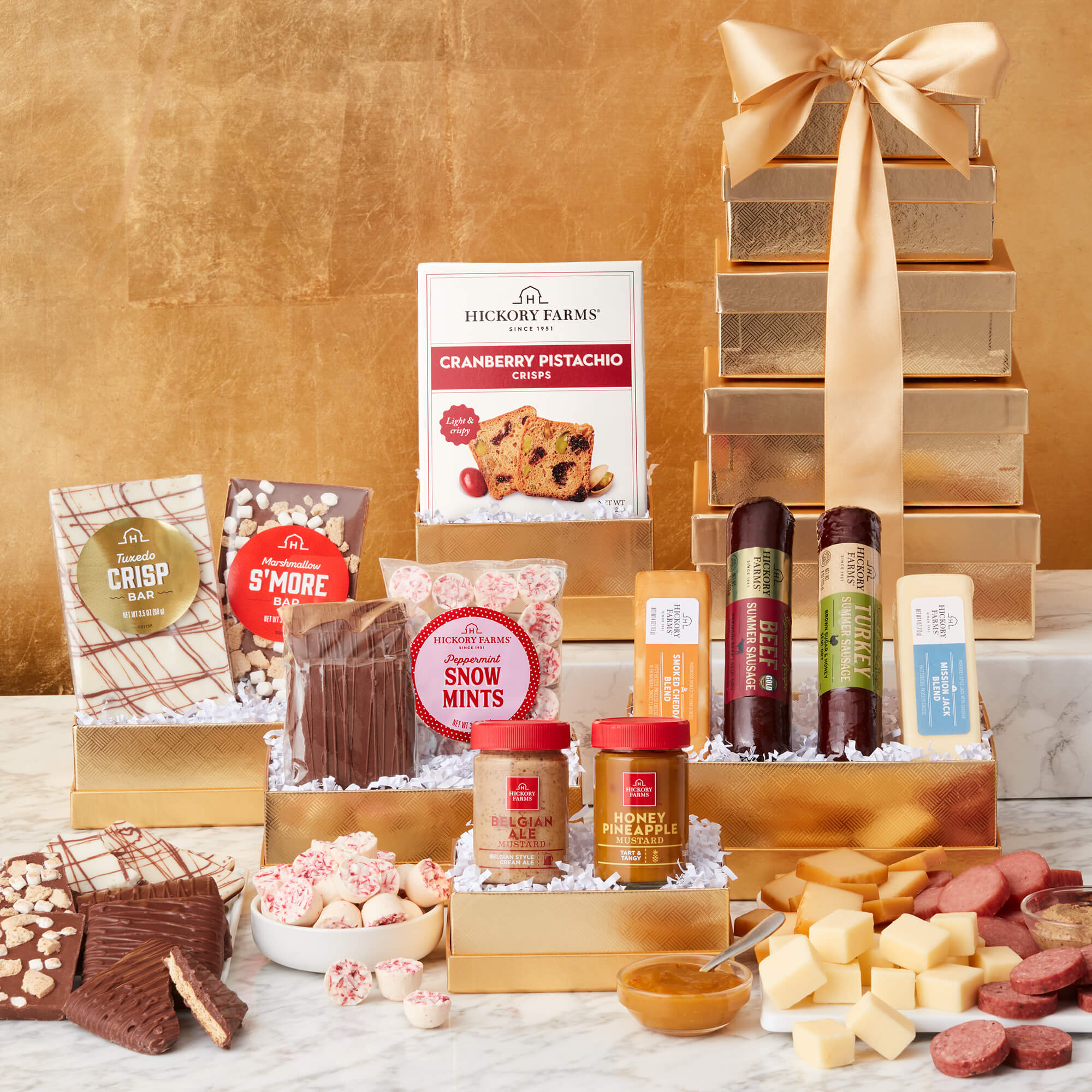 Solid Gold Gift Tower includes beef sausage, turkey sausage, various cheeses, mustards, crackers, mints, and chocolate