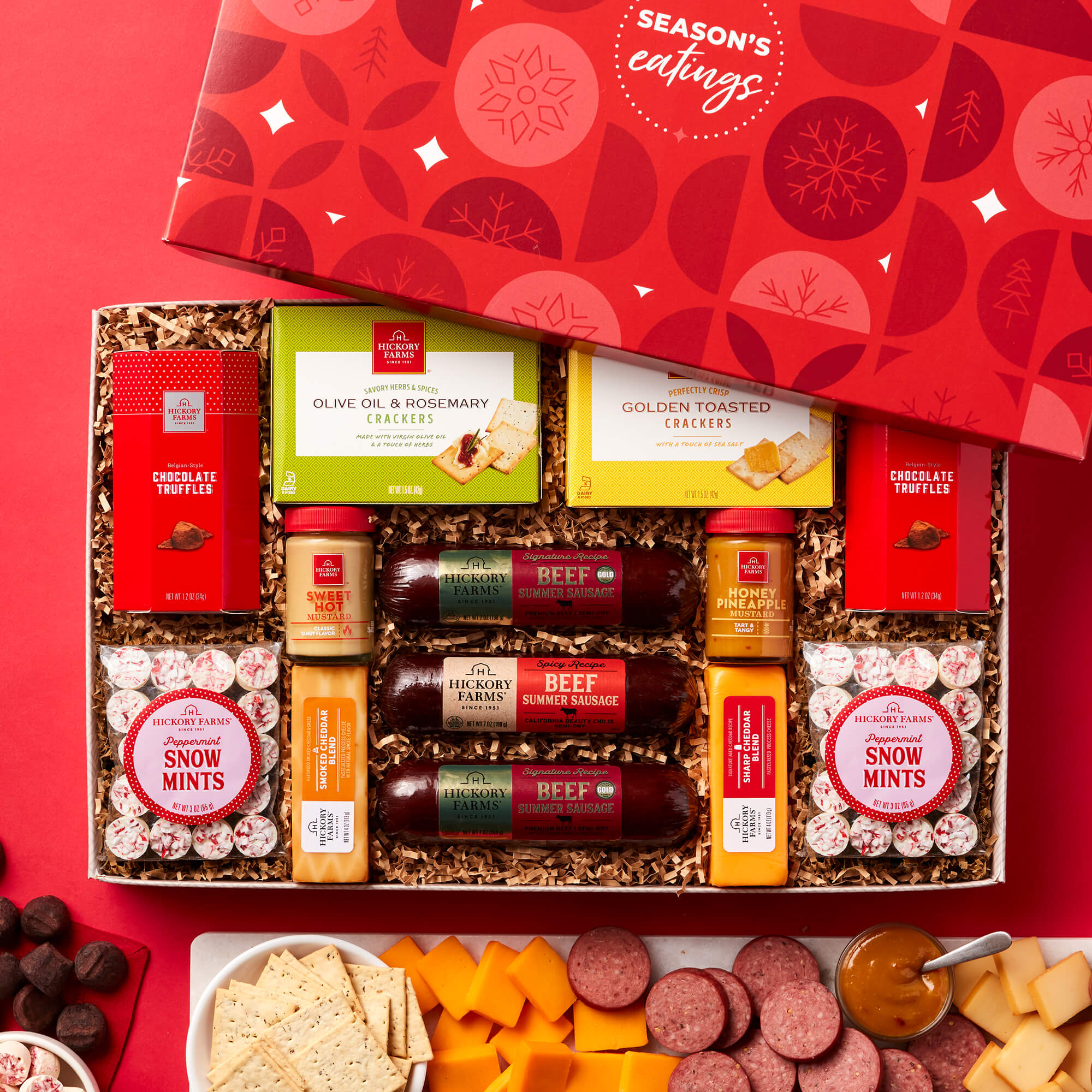 Sweet and Savory Gift Box includes beef sausage, various cheeses, mustards, crackers, mints, and chocolate