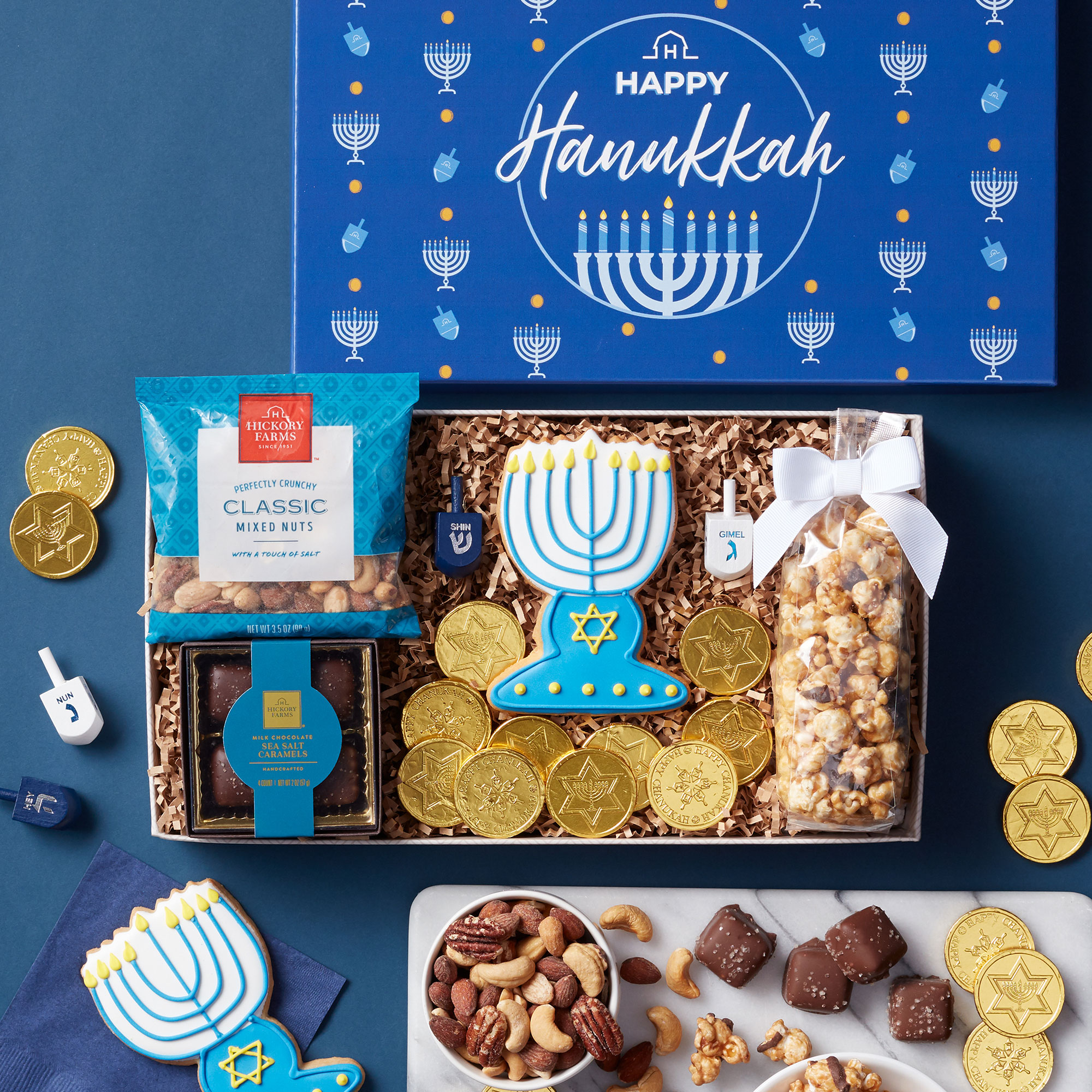 Milk Chocolate Sea Salt Caramels, Chocolate Caramel Corn, Mixed Nuts, a Menorah Sugar Cookie, Dreidel, and Chocolate Gelt