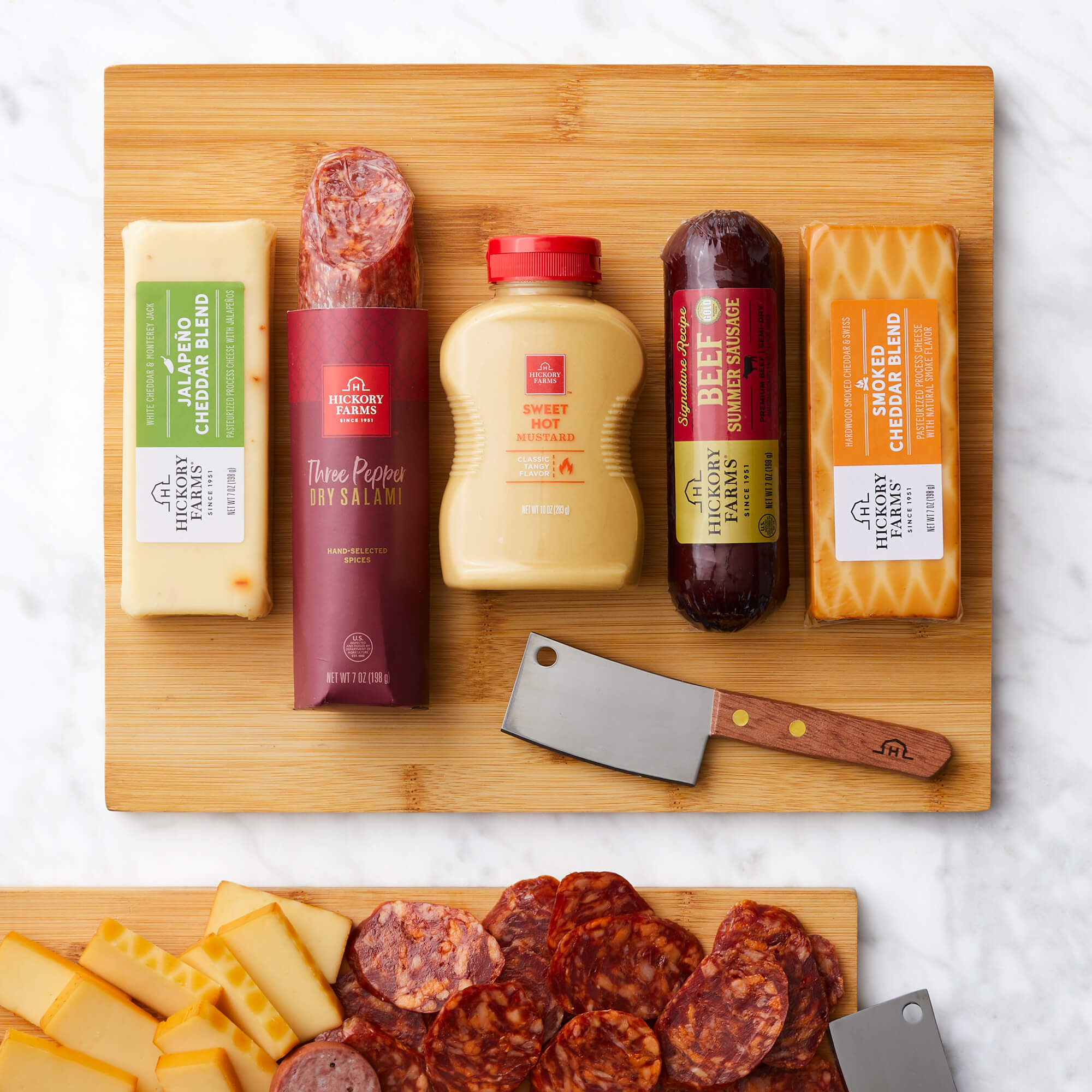 Classic Bites and Board Gift Set includes beef sausage, dry salami, mustard, various cheese, and a cutting board