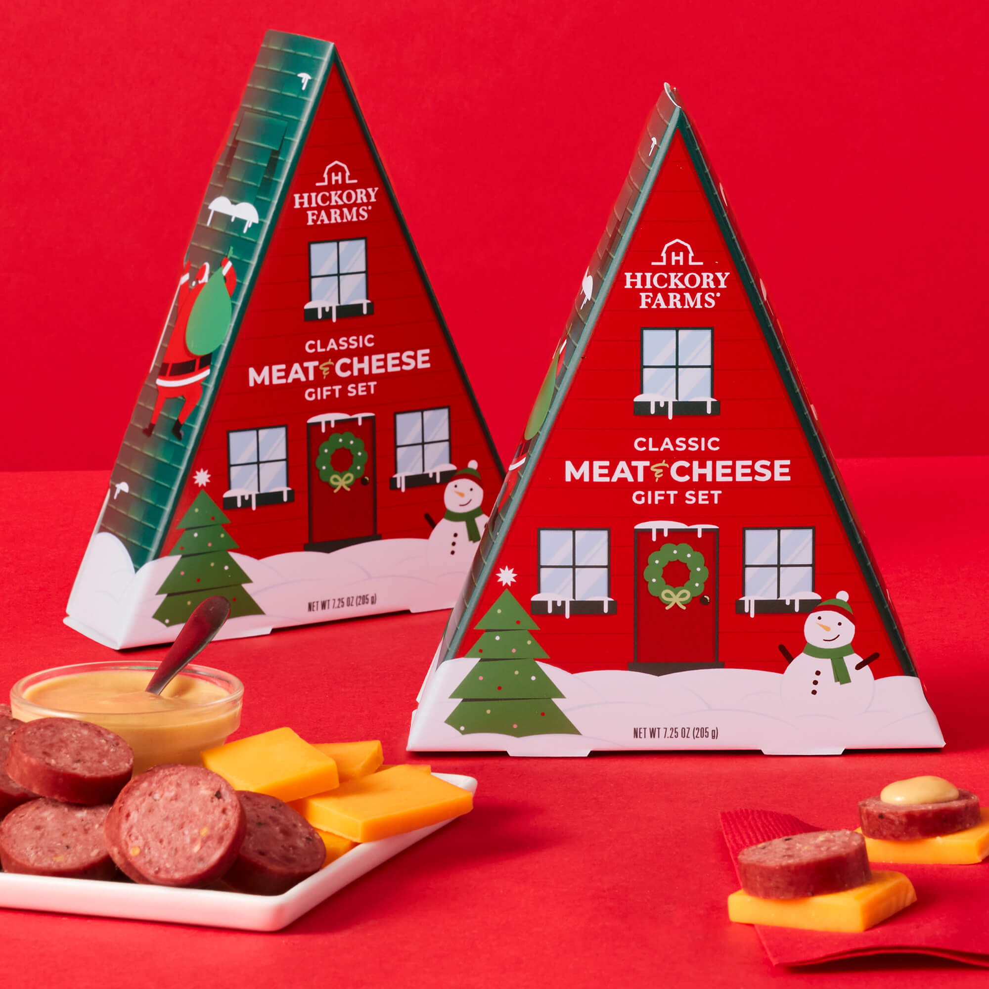 Classic Meat and Cheese Stocking Stuffer boxes shaped as a-frame cabins with winter scenes