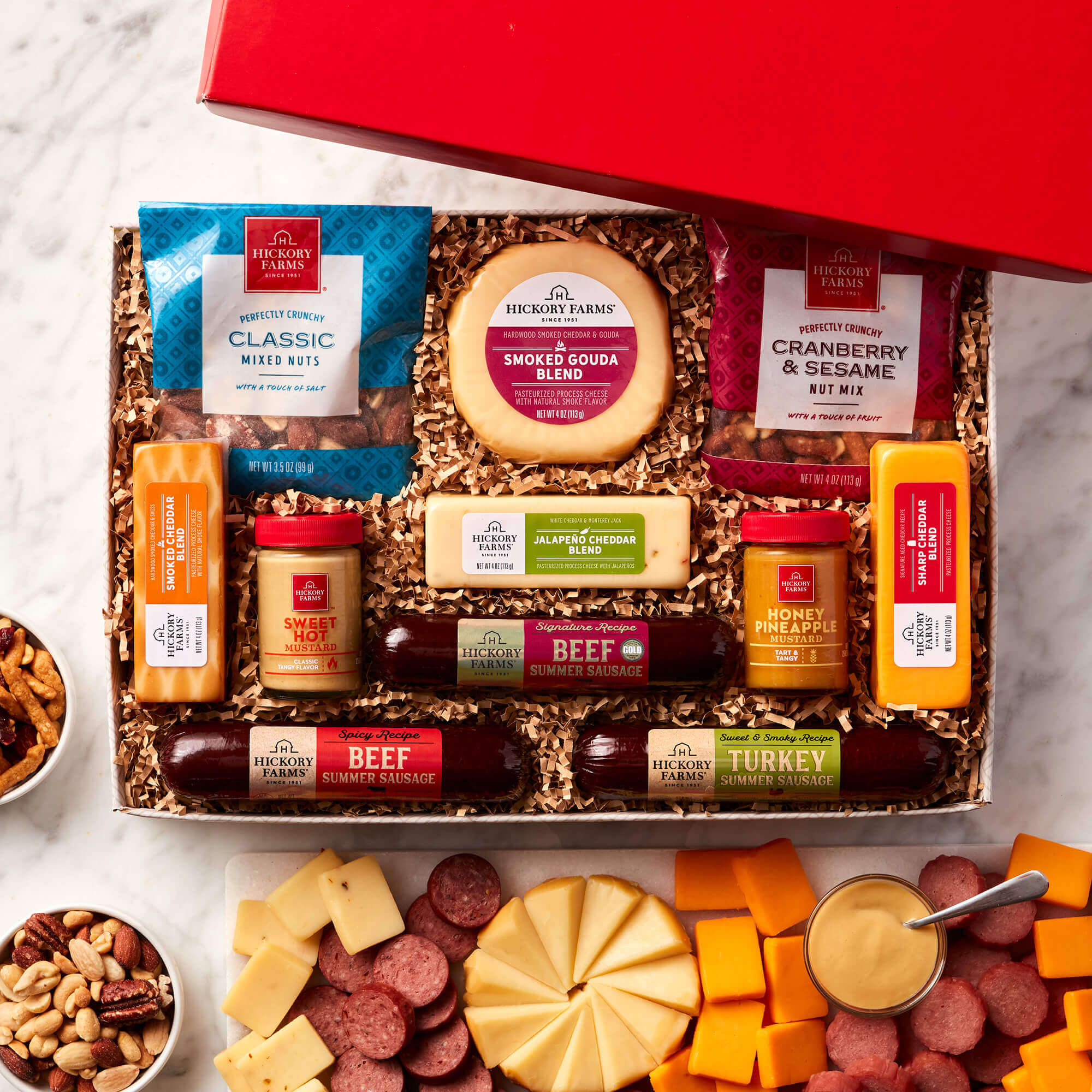 The Give Back Gift Box includes beef, turkey, and spicy sausage, mustard, nuts, and various cheeses