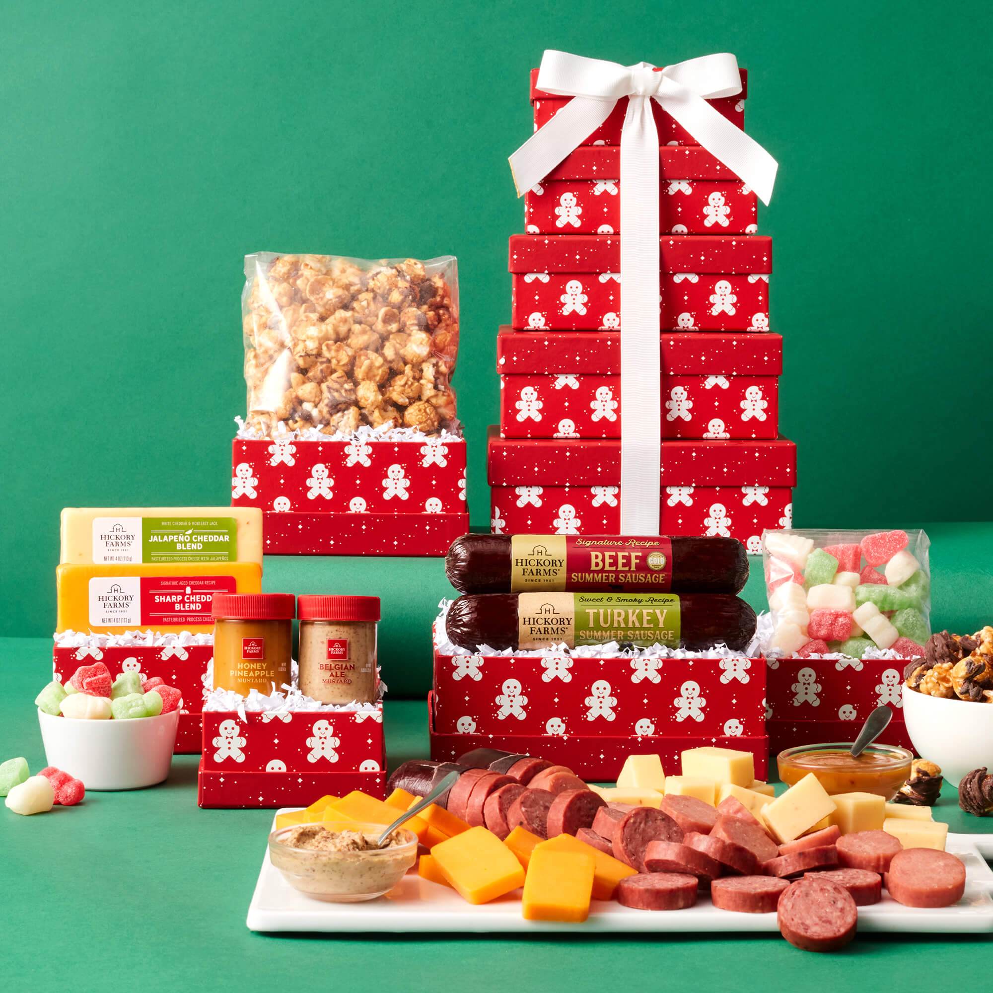 Holiday Sweet and Savory Gift Tower includes beef sausage, turkey sausage, various cheeses, mustards, popcorn, and candy