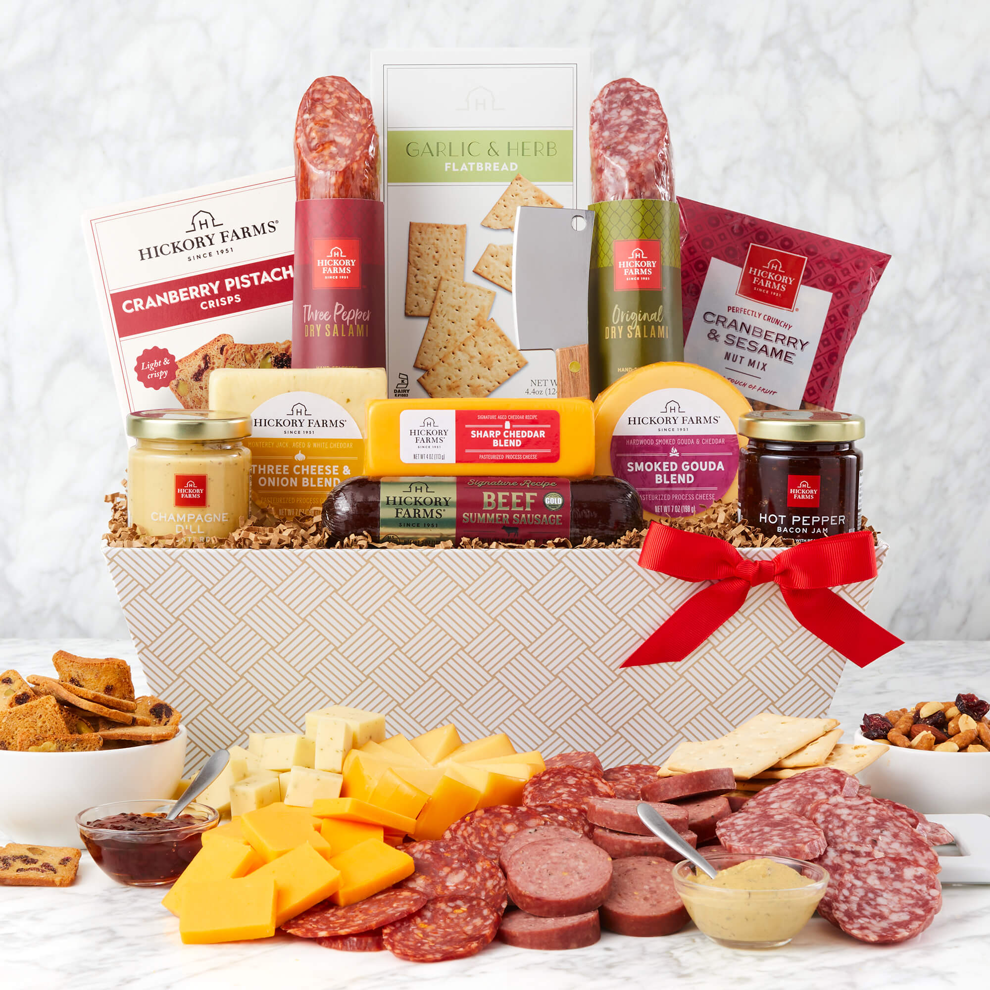 Deluxe Charcuterie Gift Basket includes beef sausage, various cheeses, jam, mustard, crackers, and nuts