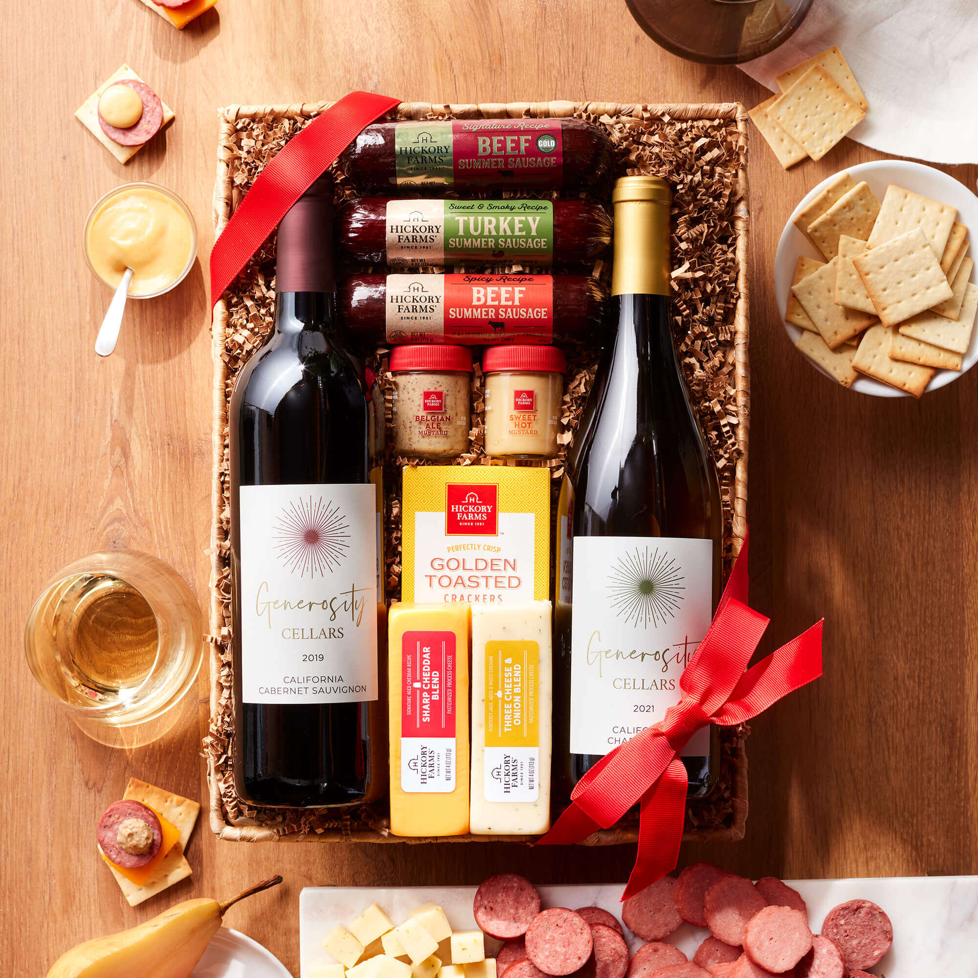 Hearty Bites and Wine Gift Basket includes beef, spicy, and turkey sausage, various cheeses, mustards, crackers and wine